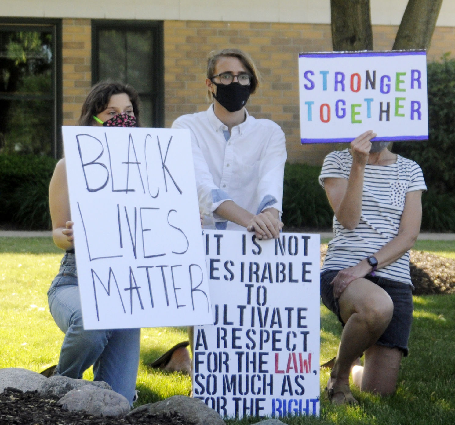Protesters kneel